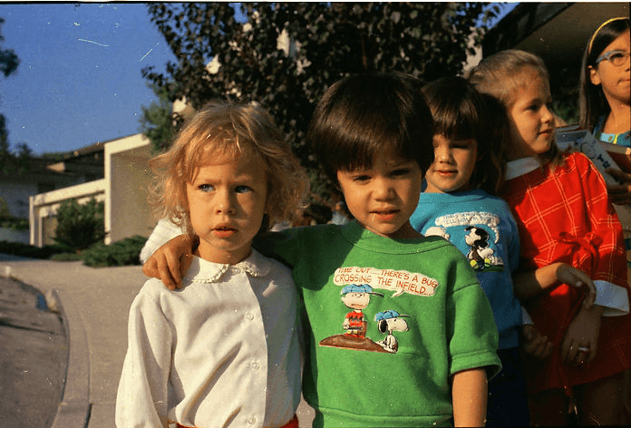 Laurelwood children lined up outdoors in the early 1970s, waiting for the school bus.